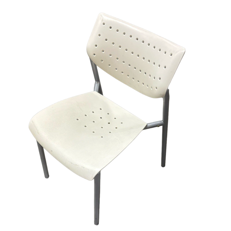 White metal chair with a perforated back and seat, gray tubular legs, shown from an angled view.